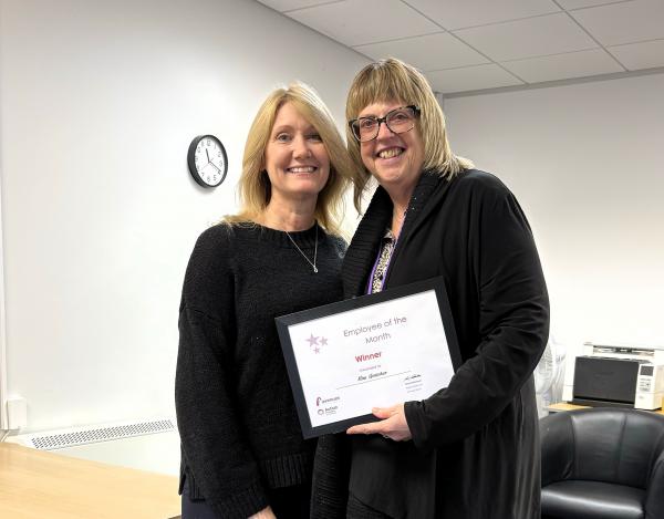 Kim stands with her manager Danielle (left) with her award certificate.