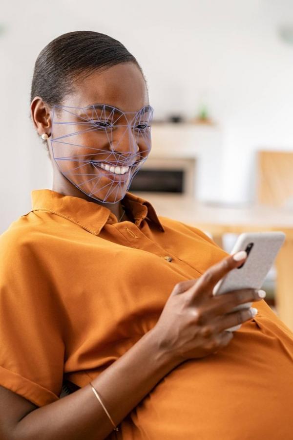 pregnant woman smiling at her phone