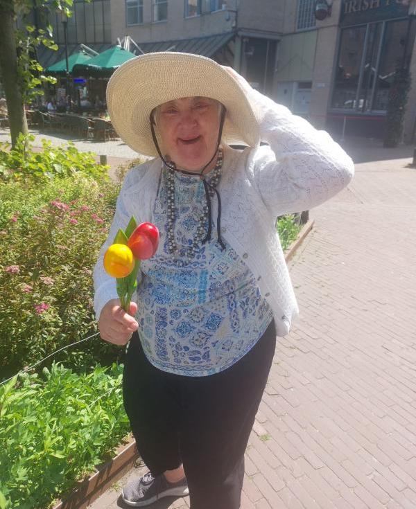 Tulips! One of the people on the trip stands with wooden tulips in her hand and wearing a lovely hat for the sun.