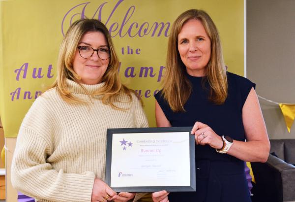 Georgie is presented with an award by Karina Hourd.