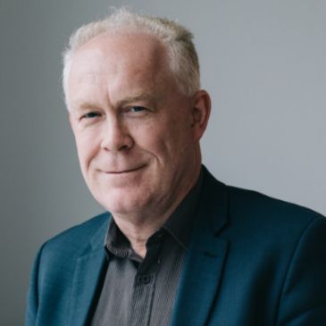 A person (Richard Morriss) is smiling at the camera