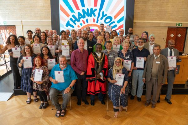 A group of celebrate winning awards as part of Bristol Community Festival