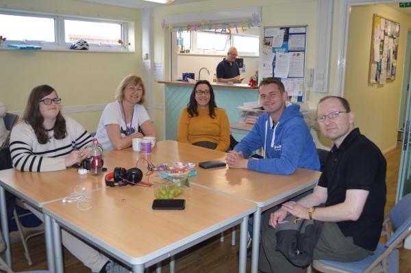 A photo at our social group in Portsmouth with people sat around a table.