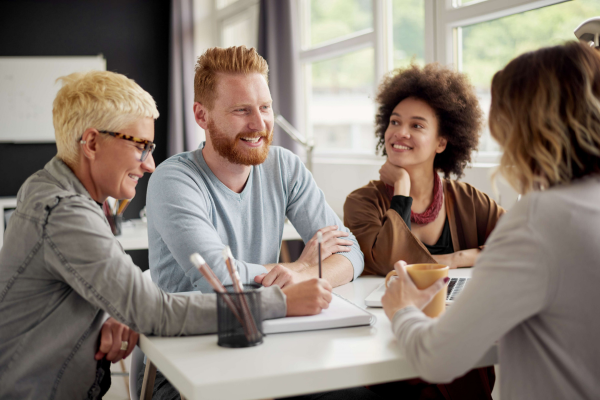 Four people sat around a table talking